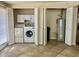 Convenient laundry room featuring a washer, dryer, cabinets, and water heater for added functionality at 1001 W 17Th St, Tempe, AZ 85281