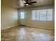 Sunlit living room with tile flooring, a ceiling fan, and a bright front door and large window at 1001 W 17Th St, Tempe, AZ 85281