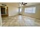 Spacious living room features tile floors, a ceiling fan, and a bright window, providing a cozy living space at 1001 W 17Th St, Tempe, AZ 85281