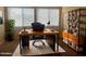 Well-lit home office featuring a spacious desk, comfortable chair, and stylish bookcase at 1001 W 17Th St, Tempe, AZ 85281