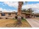 Charming ranch-style home with a covered carport and mature landscaping at 10716 W Peoria Ave, Sun City, AZ 85351