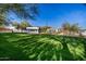 Expansive backyard featuring a lush lawn and mature trees providing ample shade at 10800 E Cactus Rd # 7, Scottsdale, AZ 85259