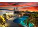 Beautiful backyard with pool, jacuzzi, waterfall, outdoor lighting, and palm trees at 10800 E Cactus Rd # 7, Scottsdale, AZ 85259