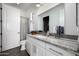 Bright bathroom showcasing granite countertop vanity with white cabinets and tiled shower at 10800 E Cactus Rd # 7, Scottsdale, AZ 85259