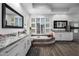 Bright bathroom with large mirror, marble counters, tile floors, and soaking tub with steps at 10800 E Cactus Rd # 7, Scottsdale, AZ 85259