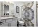 Bright bathroom with tile floors, patterned shower curtain, and granite countertop vanity at 10800 E Cactus Rd # 7, Scottsdale, AZ 85259