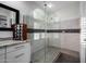 Bathroom features frameless glass shower with tile surround and granite countertop vanity at 10800 E Cactus Rd # 7, Scottsdale, AZ 85259