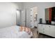 Bedroom with ensuite bathroom, hardwood floors and white dresser with blue accents at 10800 E Cactus Rd # 7, Scottsdale, AZ 85259