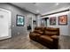 Entertainment room featuring a comfortable leather sofa, wood floors, and home theater decor at 10800 E Cactus Rd # 7, Scottsdale, AZ 85259