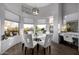 Bright dining area with a round table, stylish chairs, and abundant natural light from surrounding windows at 10800 E Cactus Rd # 7, Scottsdale, AZ 85259