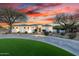 Stunning home exterior at sunset featuring a circular driveway and mature desert landscaping at 10800 E Cactus Rd # 7, Scottsdale, AZ 85259