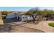 Charming single-story home featuring a spacious driveway, mature trees, and manicured landscaping at 10800 E Cactus Rd # 7, Scottsdale, AZ 85259