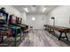 Spacious game room featuring multiple pinball machines and a shuffleboard table for entertainment at 10800 E Cactus Rd # 7, Scottsdale, AZ 85259