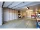 Spacious garage with ample storage cabinets and epoxy flooring at 10800 E Cactus Rd # 7, Scottsdale, AZ 85259