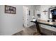 Hallway leading to rooms, featuring hardwood floors, white doors, and artwork on the walls at 10800 E Cactus Rd # 7, Scottsdale, AZ 85259