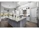 Spacious kitchen featuring a large island, modern pendant lighting, and high-end stainless steel appliances at 10800 E Cactus Rd # 7, Scottsdale, AZ 85259