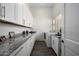 Well-lit laundry room featuring modern washer and dryer, granite counters, and stylish cabinets at 10800 E Cactus Rd # 7, Scottsdale, AZ 85259