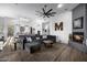 Open-concept living room featuring a fireplace, plush seating, and seamless flow to the modern kitchen at 10800 E Cactus Rd # 7, Scottsdale, AZ 85259