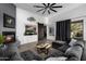 Cozy living room features a fireplace, barn door, and comfortable sectional sofa at 10800 E Cactus Rd # 7, Scottsdale, AZ 85259