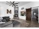 Inviting living room featuring a cozy fireplace and unique barn door detail at 10800 E Cactus Rd # 7, Scottsdale, AZ 85259