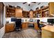 Spacious home office featuring custom built-in wooden bookshelves and wood floors at 10800 E Cactus Rd # 7, Scottsdale, AZ 85259