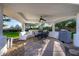 Inviting outdoor dining area with built-in seating, grill, and ceiling fan, perfect for entertaining at 10800 E Cactus Rd # 7, Scottsdale, AZ 85259