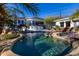 Sparkling pool complemented by rock features and lush tropical landscaping at 10800 E Cactus Rd # 7, Scottsdale, AZ 85259