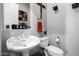 A clean powder room is complete with elegant fixtures, a stylish mirror, and fresh decor at 10800 E Cactus Rd # 7, Scottsdale, AZ 85259