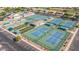 Aerial view highlighting the community's amenities, including tennis courts and bocce ball courts at 10960 E Monte Ave # 164, Mesa, AZ 85209