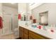 This bathroom features double sinks, tile floors, oak cabinets and a seamless glass enclosed shower at 10960 E Monte Ave # 164, Mesa, AZ 85209