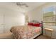 This light and bright bedroom features large windows, neutral carpeting, and a ceiling fan at 10960 E Monte Ave # 164, Mesa, AZ 85209