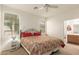 This bedroom features large windows and neutral carpeting and opens to the ensuite bathroom at 10960 E Monte Ave # 164, Mesa, AZ 85209