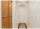 Bright entryway with tile flooring, a pantry, and a white front door with arched window at 10960 E Monte Ave # 164, Mesa, AZ 85209