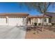 Inviting single-story home with a two-car garage, neutral stucco, and xeriscaped front yard at 10960 E Monte Ave # 164, Mesa, AZ 85209