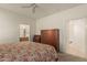 This bedroom features neutral carpeting and an ensuite bathroom with a view of the walk-in closet at 10960 E Monte Ave # 164, Mesa, AZ 85209