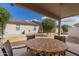 Inviting covered patio space featuring outdoor seating and a view of the beautifully landscaped backyard at 10960 E Monte Ave # 164, Mesa, AZ 85209
