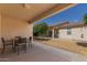 Relaxing covered patio with a table and chairs overlooking a well-maintained backyard at 10960 E Monte Ave # 164, Mesa, AZ 85209