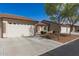 A beautiful street view of single-story homes featuring two-car garages and well-maintained landscaping at 10960 E Monte Ave # 164, Mesa, AZ 85209