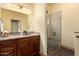 Bathroom featuring a granite vanity, tile floors, and a glass shower with built-in seat at 11351 E Pampa Ave, Mesa, AZ 85212