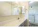 Clean bathroom featuring a sink, mirrored cabinet, and a walk-in shower with a glass door at 12243 S Chippewa Dr, Phoenix, AZ 85044