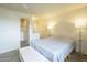 Cozy bedroom showcasing a comfortable bed, bedside lamps, and a walk-in closet at 12243 S Chippewa Dr, Phoenix, AZ 85044