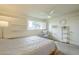 Bright bedroom with a ceiling fan, window shutters, and decor shelving at 12243 S Chippewa Dr, Phoenix, AZ 85044
