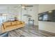 Bright living room featuring vaulted ceilings, a ceiling fan, and modern wood-look floors at 12243 S Chippewa Dr, Phoenix, AZ 85044