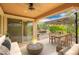 Relaxing back patio with a fire pit, dining area, and comfortable seating, perfect for outdoor entertaining at 12957 W Hummingbird Ter, Peoria, AZ 85383