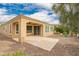 Backyard featuring a covered patio, neutral gravel landscaping, and views of the home's architecture at 12957 W Hummingbird Ter, Peoria, AZ 85383