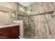Bathroom featuring a tiled shower with built-in seat and updated vanity at 12957 W Hummingbird Ter, Peoria, AZ 85383