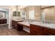This bathroom offers dual sinks, granite countertops, and dark wood cabinets at 12957 W Hummingbird Ter, Peoria, AZ 85383