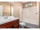 A full bathroom featuring a bathtub, shower, and a vanity sink with a cabinet at 12957 W Hummingbird Ter, Peoria, AZ 85383