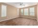 A large bedroom with three large windows, a ceiling fan, and wood look floors at 12957 W Hummingbird Ter, Peoria, AZ 85383