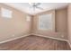 An empty bedroom featuring wood floors, light walls and a ceiling fan at 12957 W Hummingbird Ter, Peoria, AZ 85383
